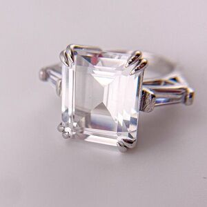 Emerald cut cubic zirconia ring with baguette cut side stones. Size 4.75.